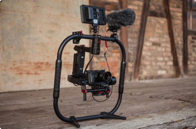 Filmmaker operating camera gear on set